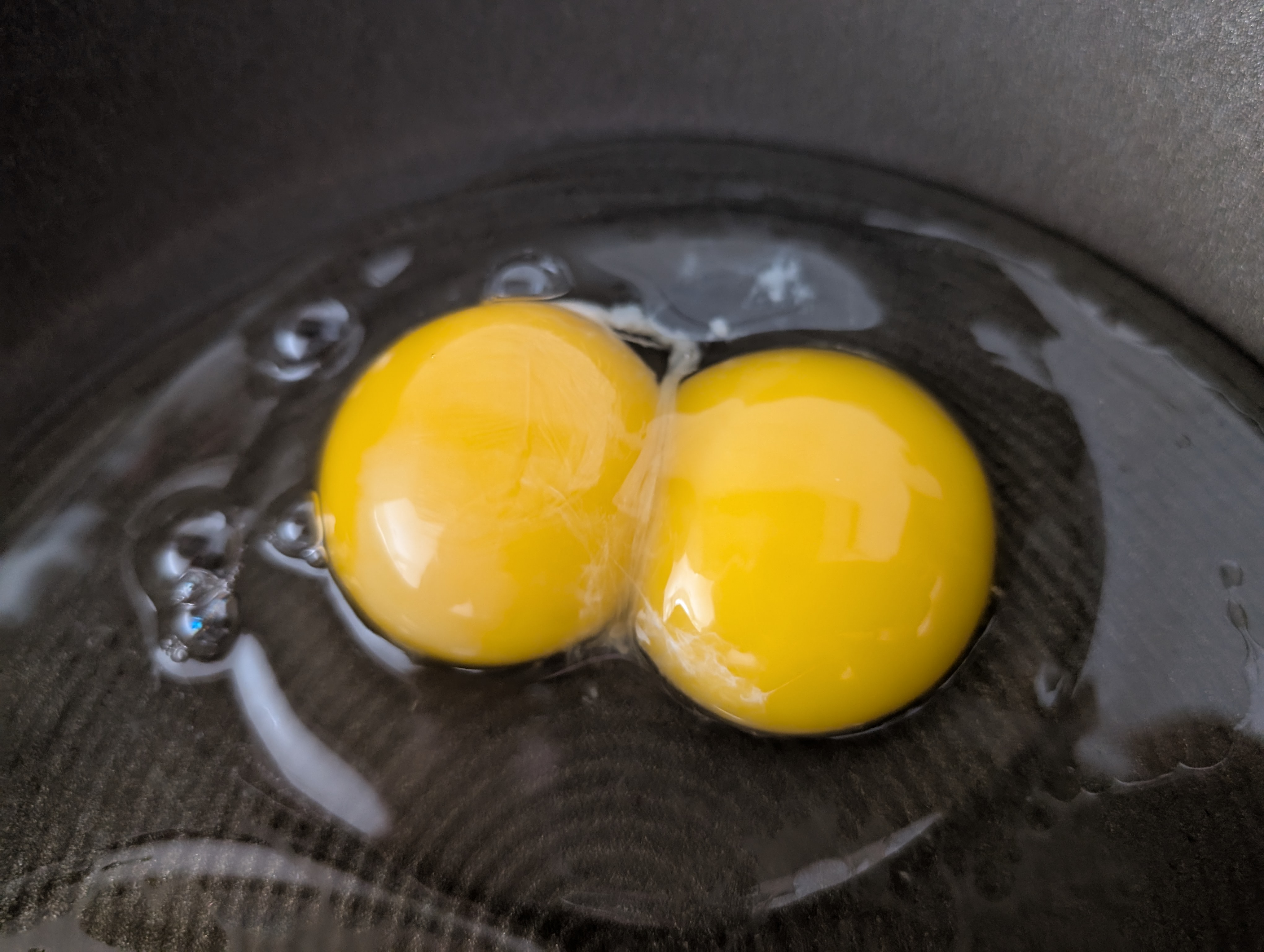 Cracked open egg with two yolk