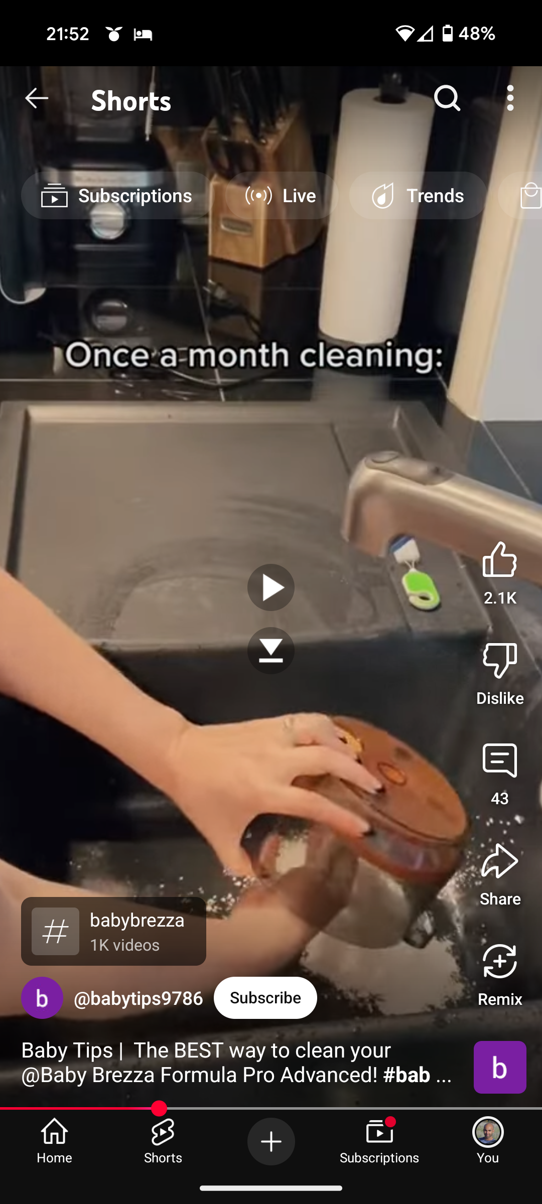 Screenshot of a YouTube Short showing baby formula being dumped in the sink
